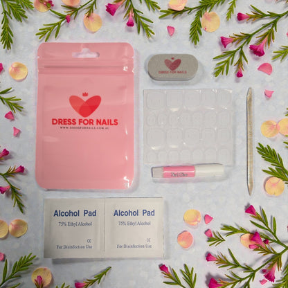 Nail Prep Kit flat lay with alcohol pads, nail glue, buffer, adhesive tabs and cuticle stick on floral background – perfect for press on nails Australia